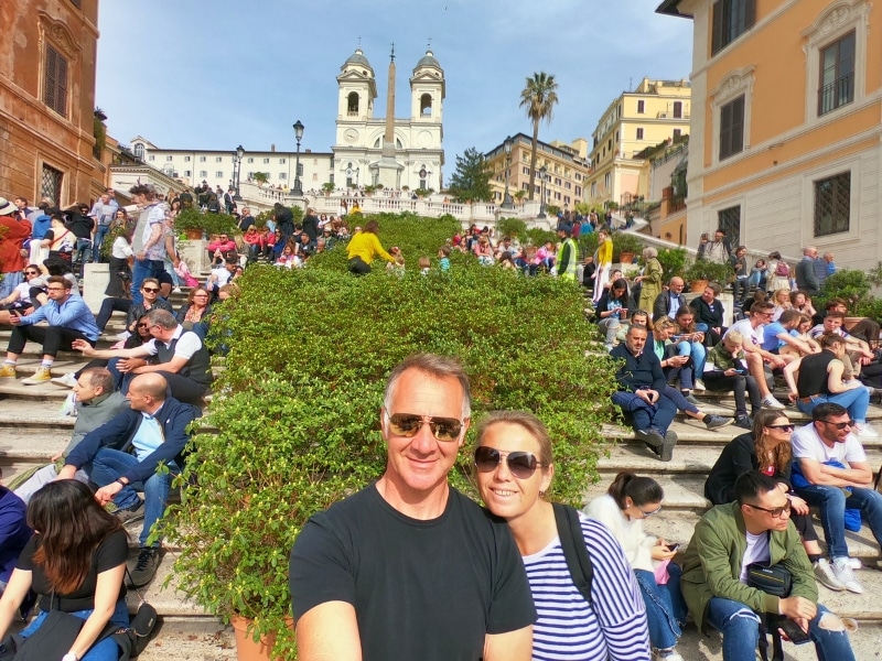 Couple stading at the foot of the Spanish Steps in Rome