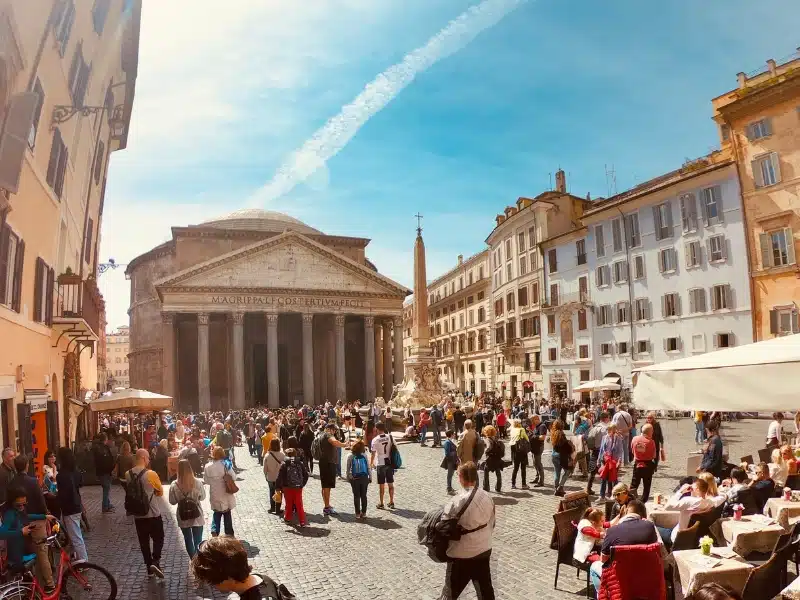 round building fronted by columns in a busy cobbled square in Rome