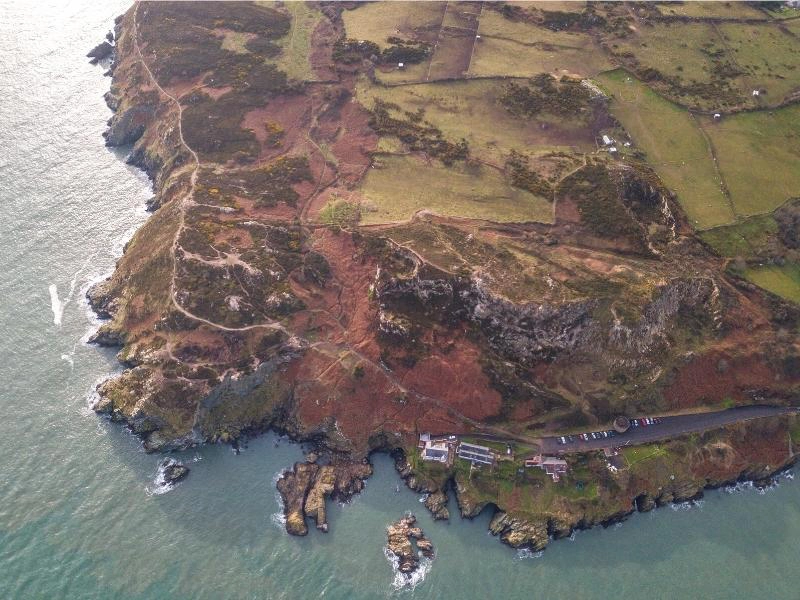 coastal path around a rocky headland seen from above