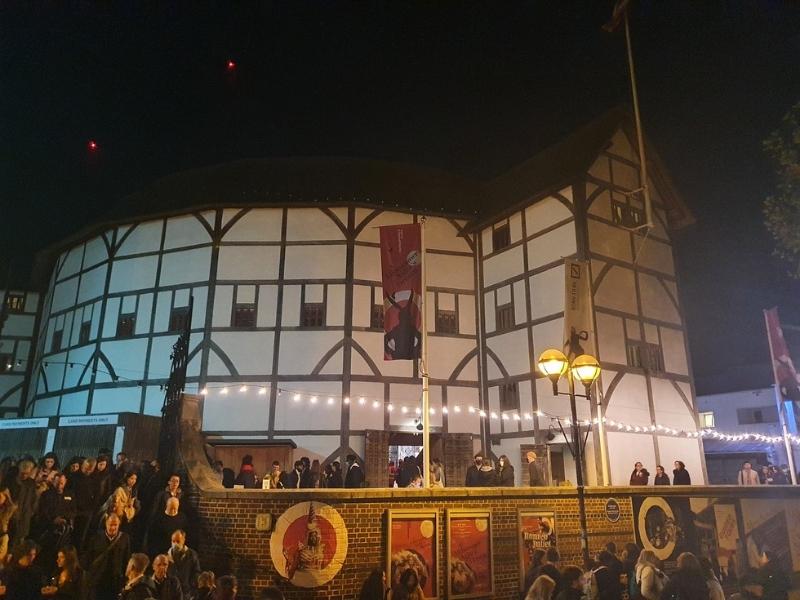 An Elizabethan theatre lit up at night