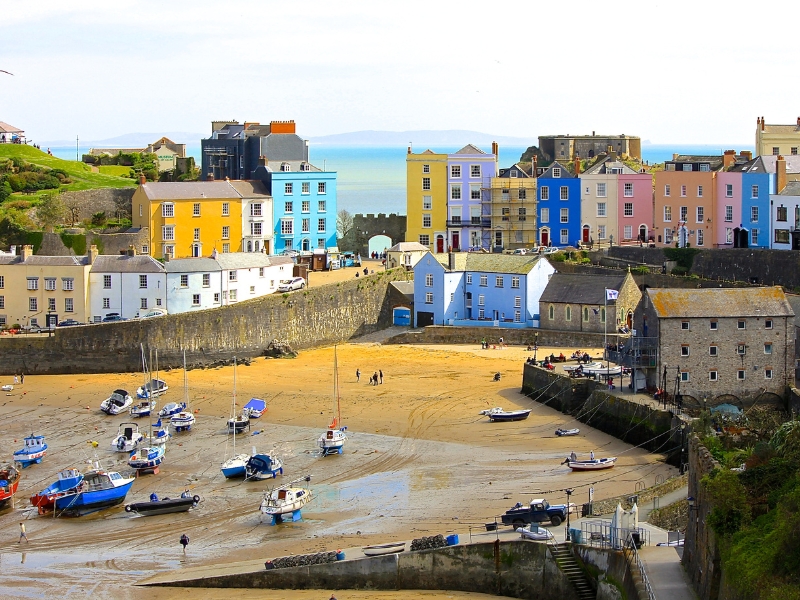 brightly painted houses and a beach with small fishing boats