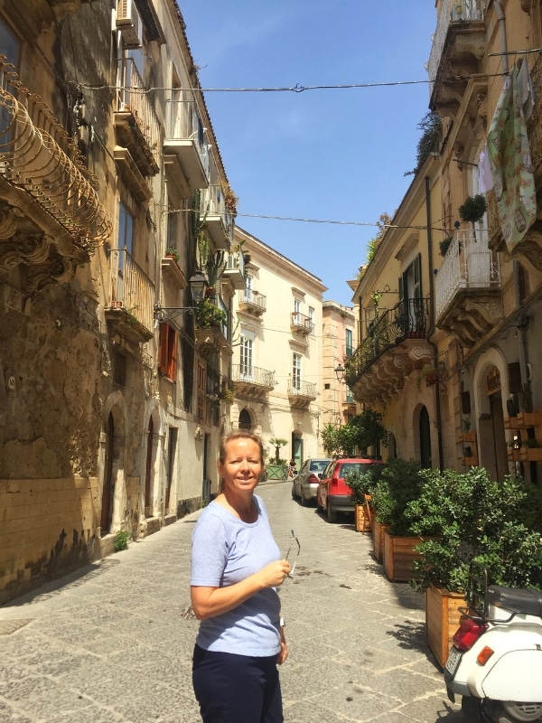 woman on a street lined with historic houses