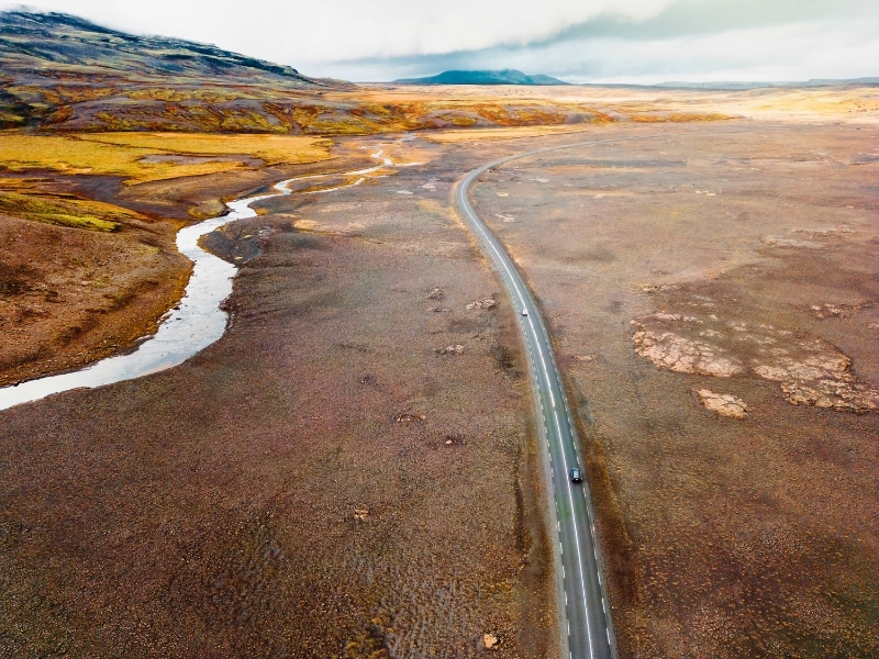 vast landscape with a road and a river running through it