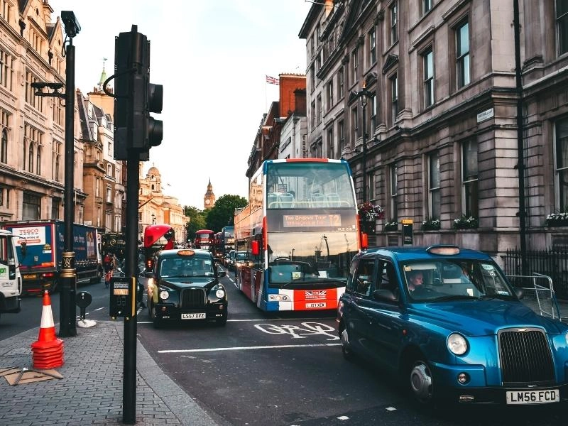 a London bus, taxis and other traffic on a busy road in London