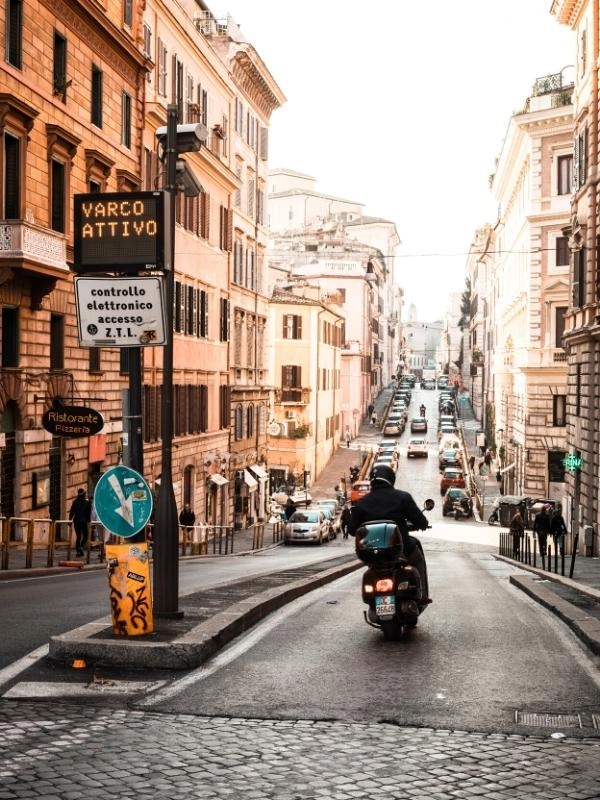 Scooter driving on a city road in Italy