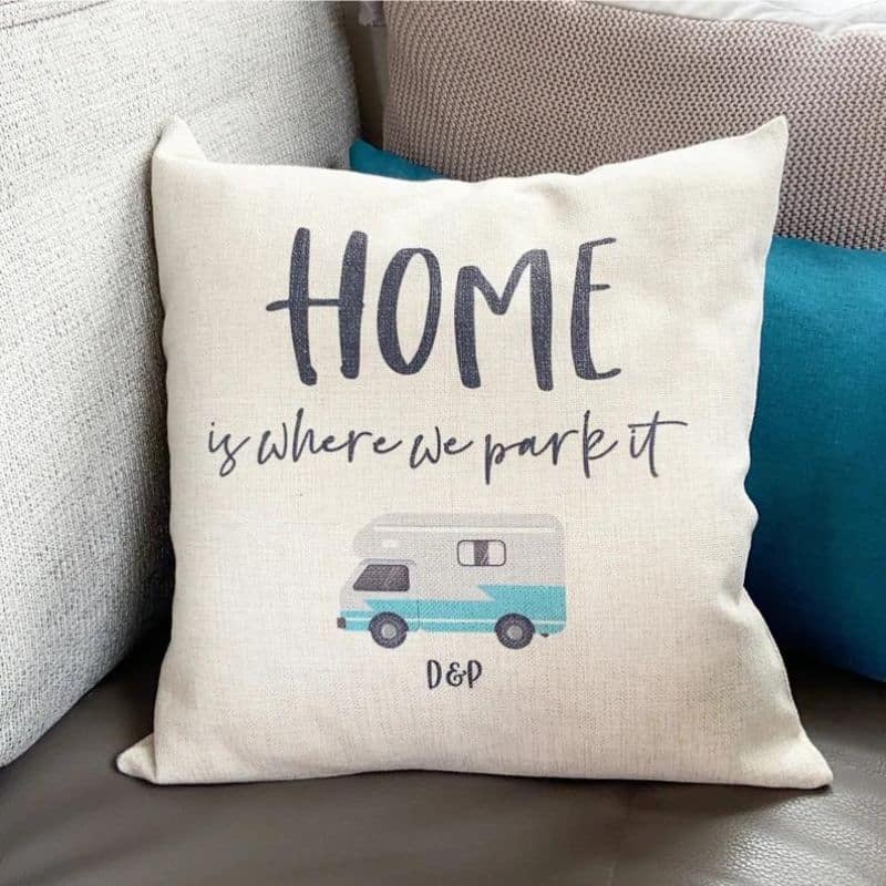 A image showing a cream pillow withe the words Home is Where We Park it and a picture of a motorhome.