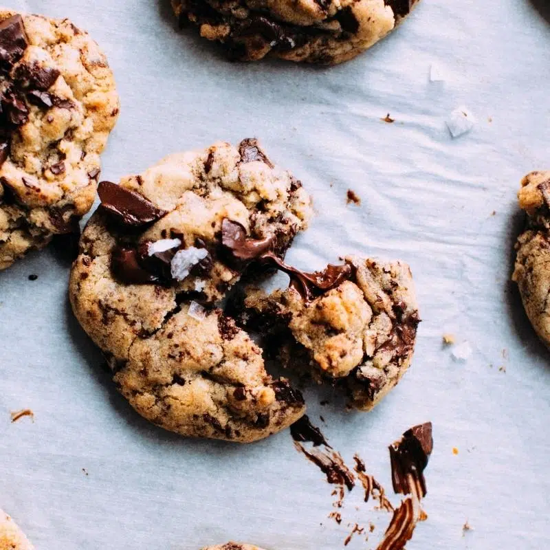 A gooey chocolate chip cooke pulled in half.