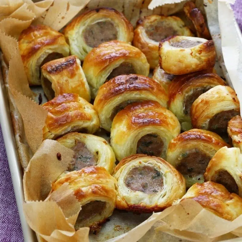 An image of a baking tin of mini sausage riolls