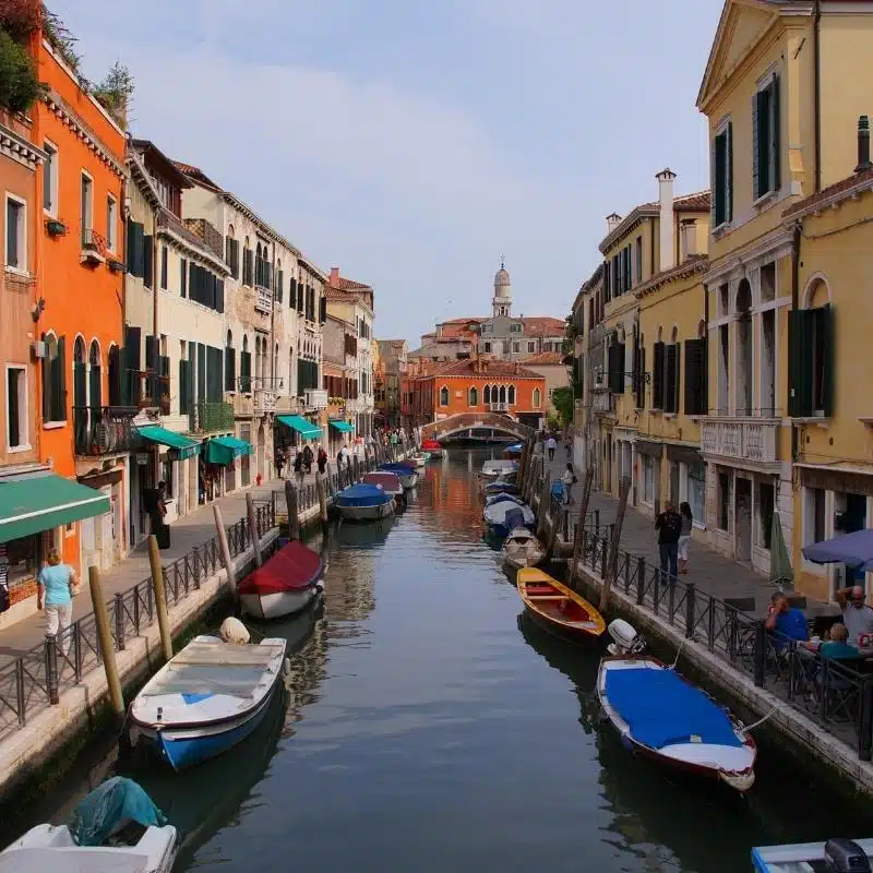 An image of a Venice street in Dorsoduro, with small boats moored along each side of the canal