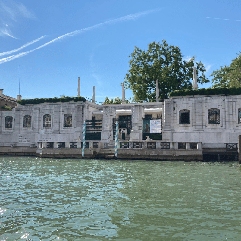 An image of the Peggy Guggenheim collection, a large white marble building on the grand canal