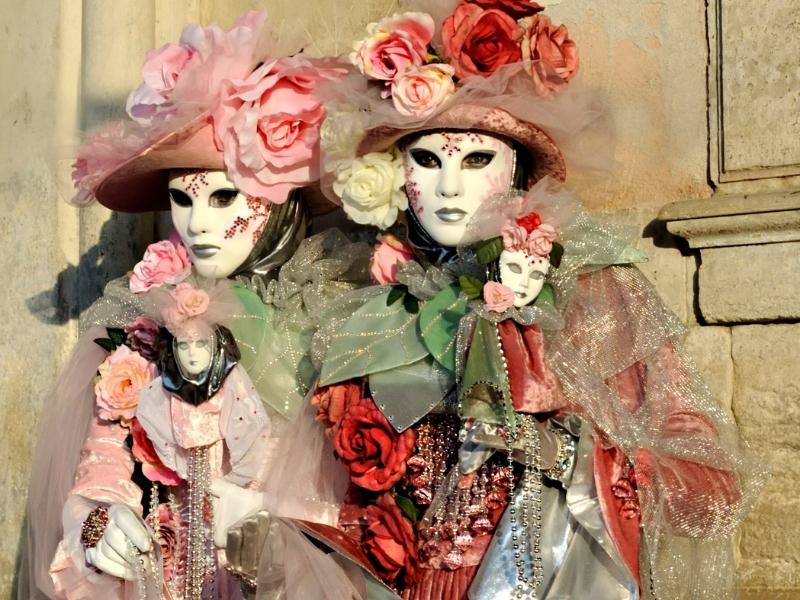 An image of two people dressed in costumes and masks for the Venice Carnivale
