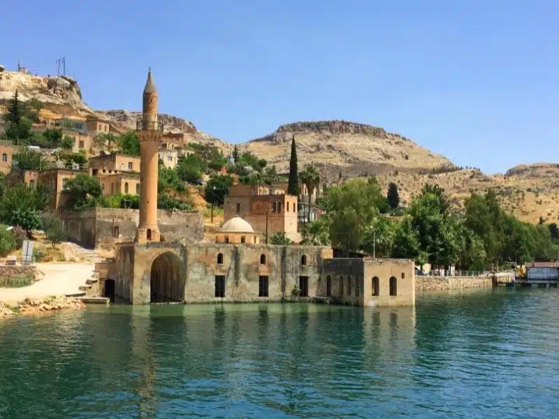 Mosque with minaret half submerged in water