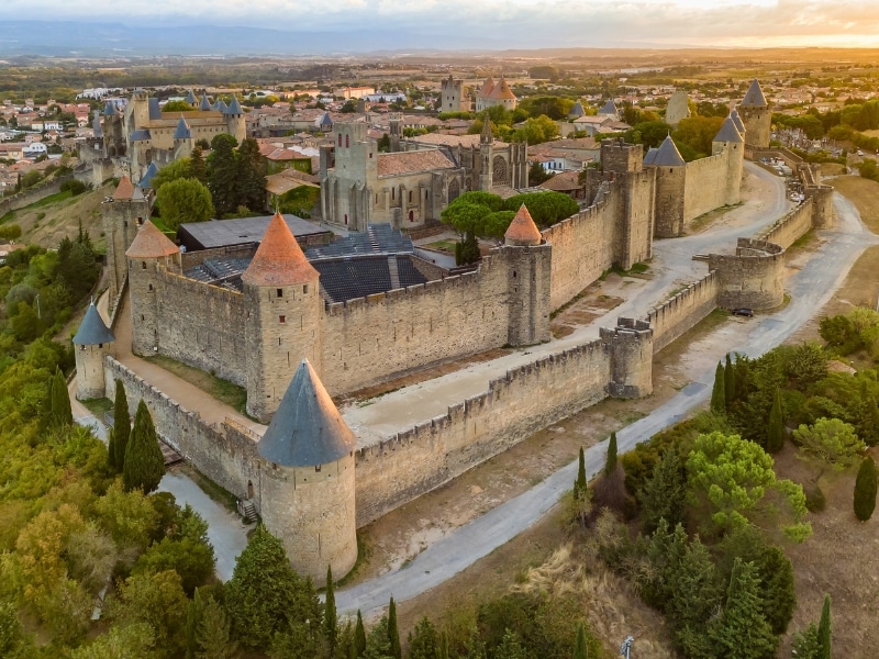 Aerial view of the medieval city of Carcassonne town and its fortress castle at sunrise, southern France.