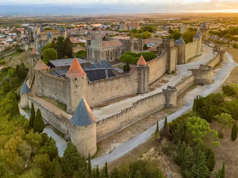 Aerial view of the medieval city of Carcassonne town and its fortress castle at sunrise, southern France.