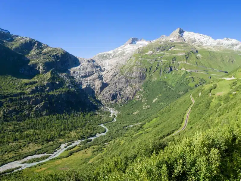 A road following a river through mountains