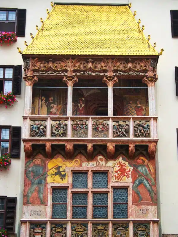 ornate balconied house with a golden roof