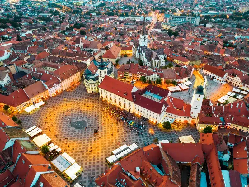 aerial view of a medieval city with red roofs and churches