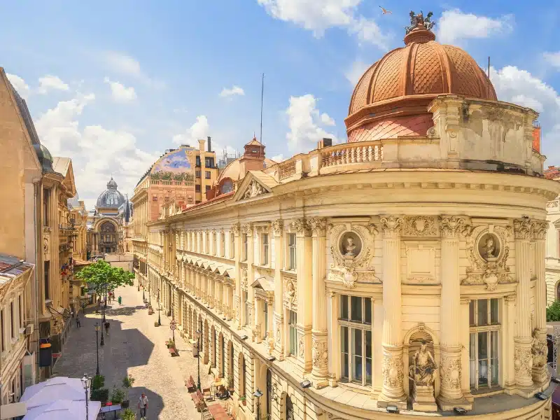 Creamy history buildings with teraccota domes by a cobbled pedestrian street