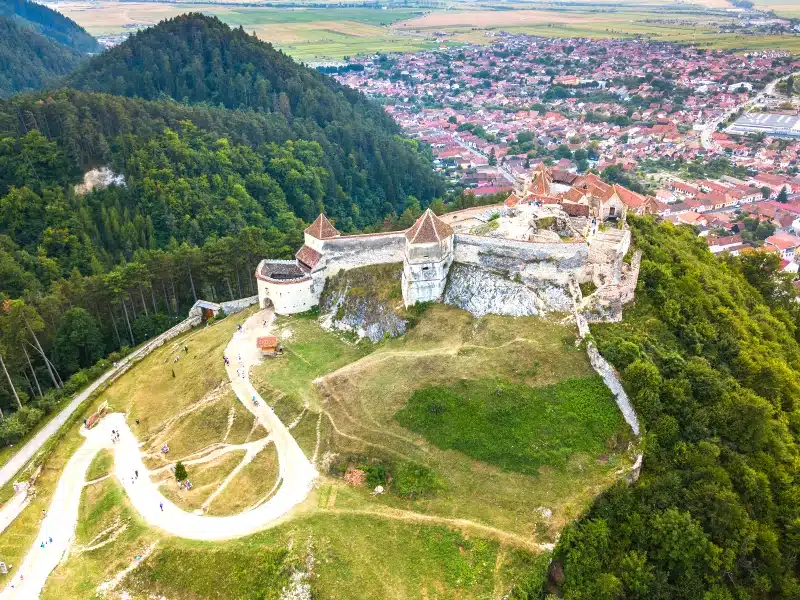 ancient castle complex on a hill above a town