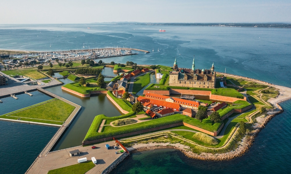 Aerial view of red roofed island castle surrounded by blue sea