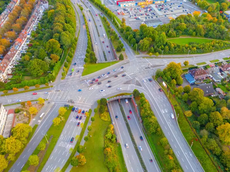Drone shot of a motorway intersection outside a town in Germany