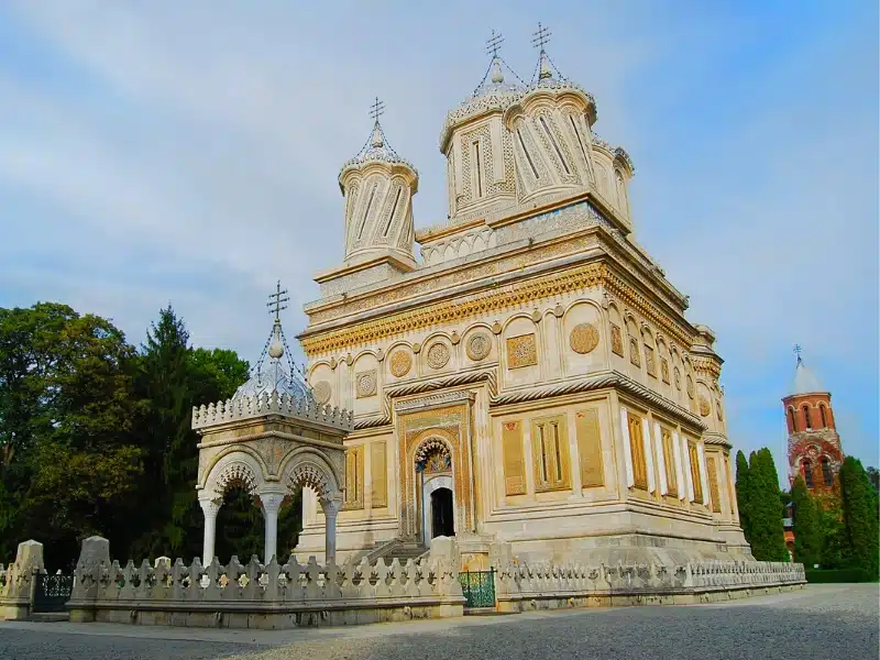 creamy coloured monastery building with ornate domes and towers