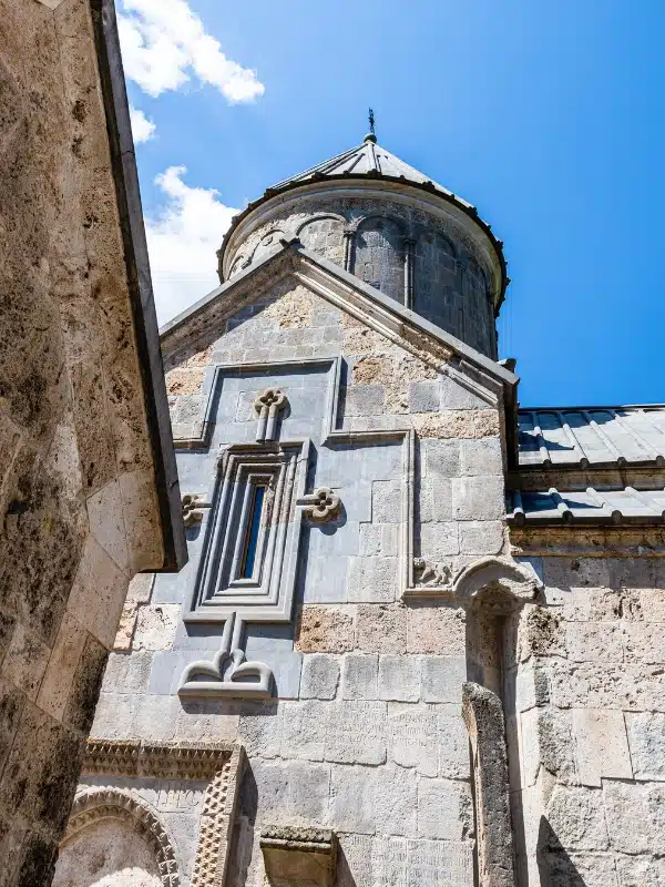 Large blocks of stone make a church building with a conical roof
