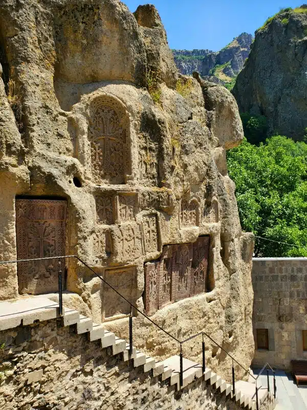 ancient stone wall with intricately carved khachkars
