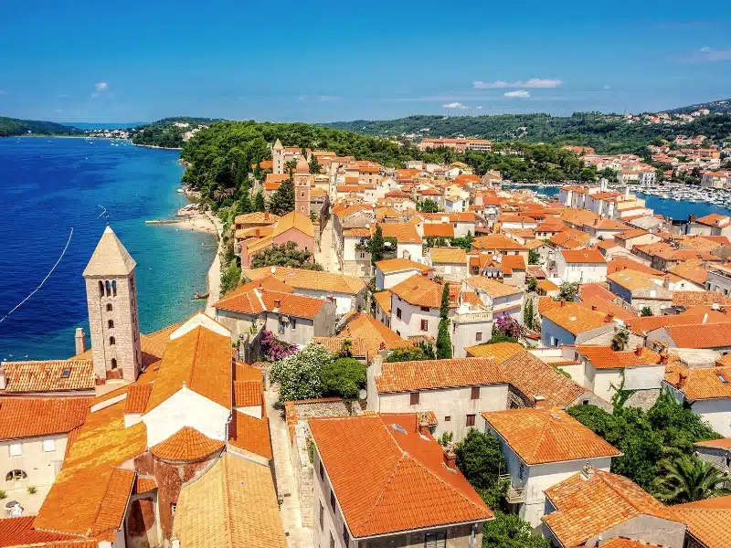 Rab town's red roofs and stone church by the sea