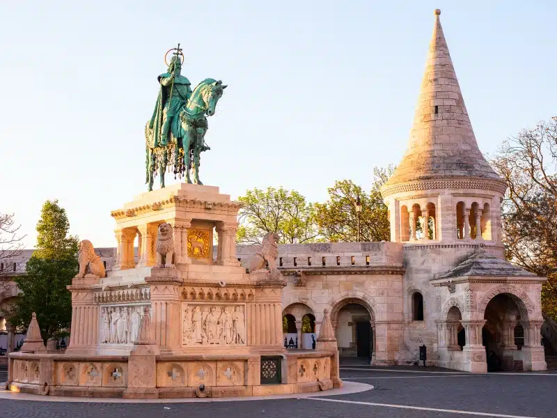 An image of Fishermans Bastion , A statue with a building and small turret in the back ground