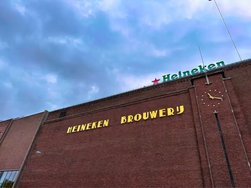 Image of a brick building with the words HEiNEKEN BROUWERY in lareg yellow letters