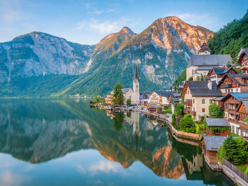 Small and pretty town by a lake with mountains in the background