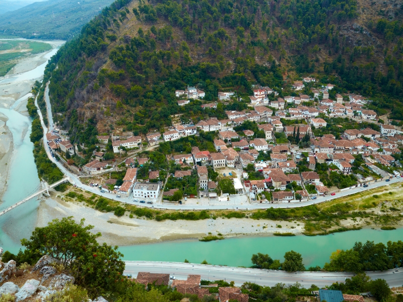 town of white houses in the bend of a green river