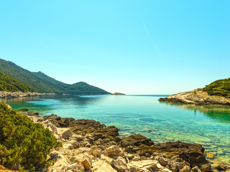cler waters off a rocky shore