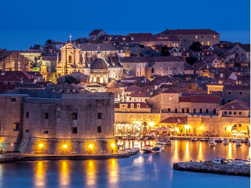 historic old town and harbor lit up at night
