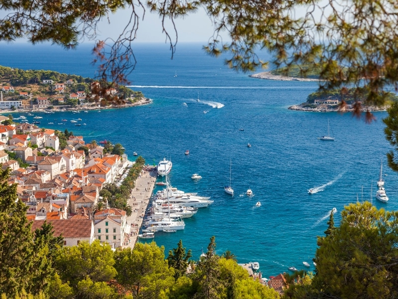 island town with sailing boats in a blue sea and smaller islands
