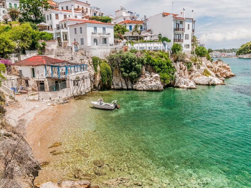 Village of white buildings to the sea with a small moored boat