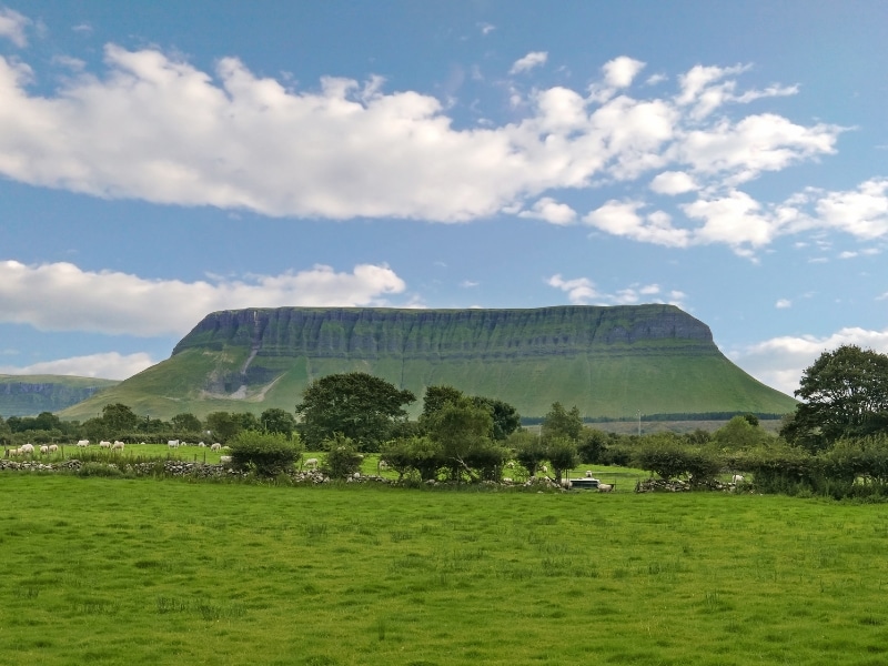 Large rocky flat topped outcrop covered with grass