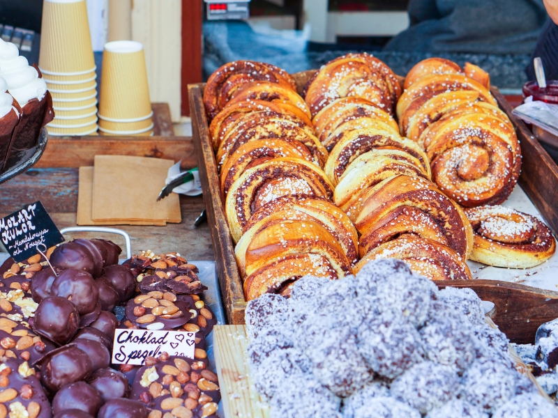 cinnamon buns and other sweet treats at a roadside stall