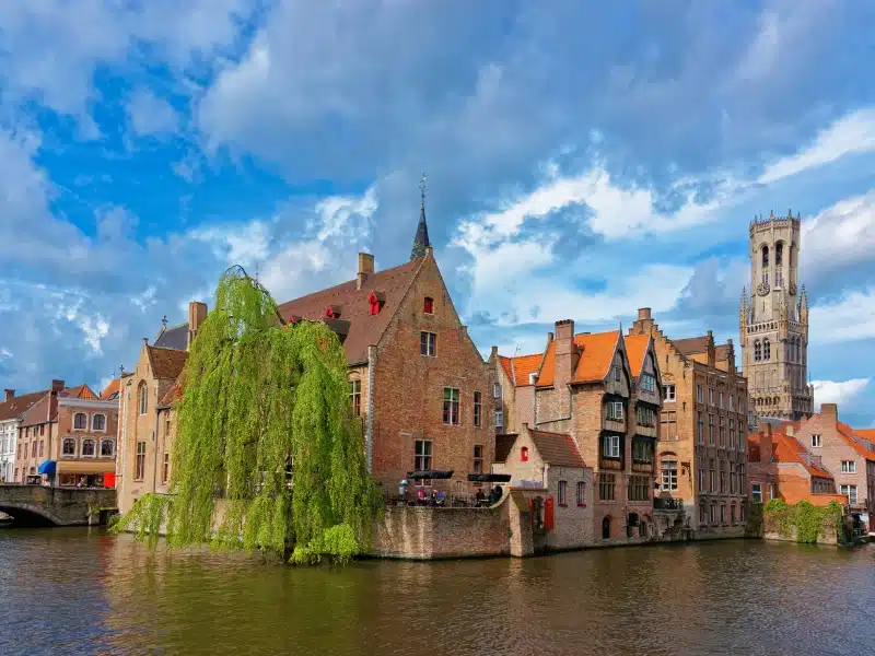 historic buildings along a wide canal in Bruges