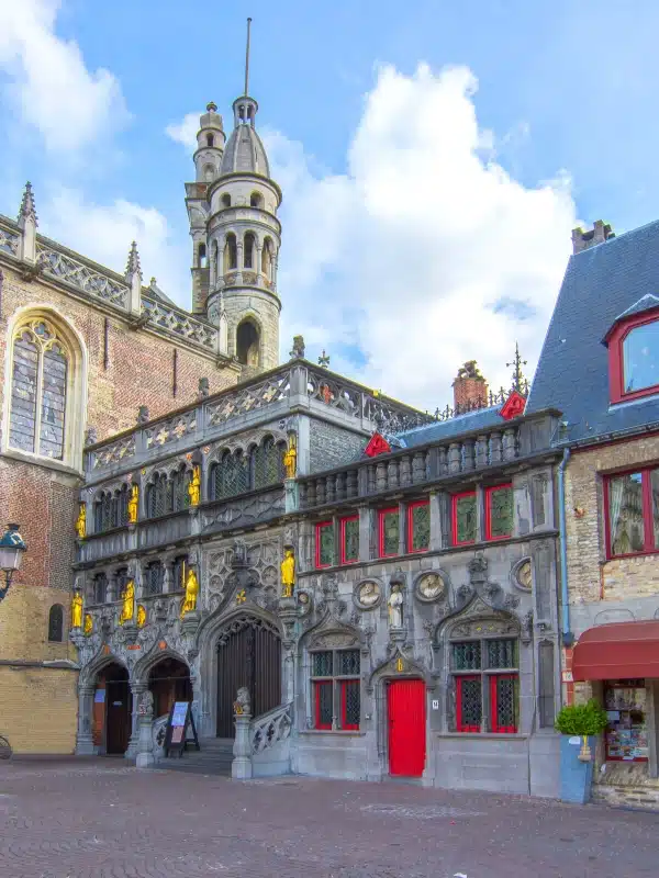 Historic grey stone basilica with red and yellow painted highlights