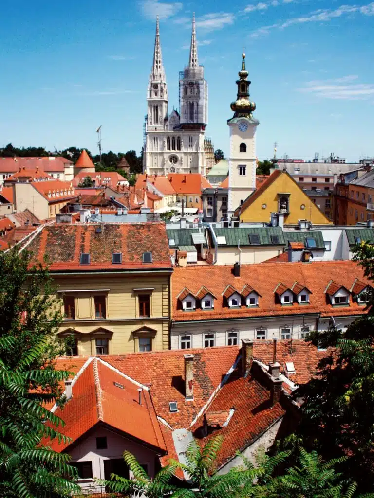 colourful houses with church towers behind dominating the skyline