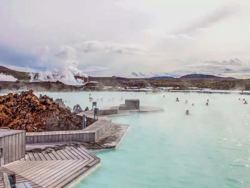 Turquoise thermal spa waters with people swimming