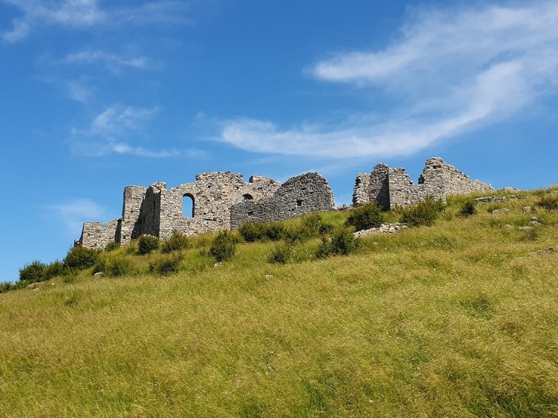 Ruined castle atop a grassy hill