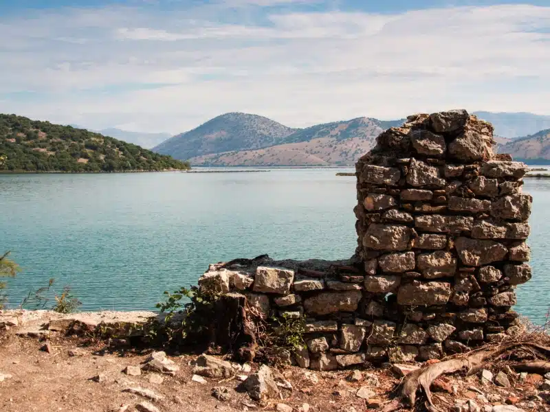 Ancient Roman wall in fromt of a lake and rolling hills