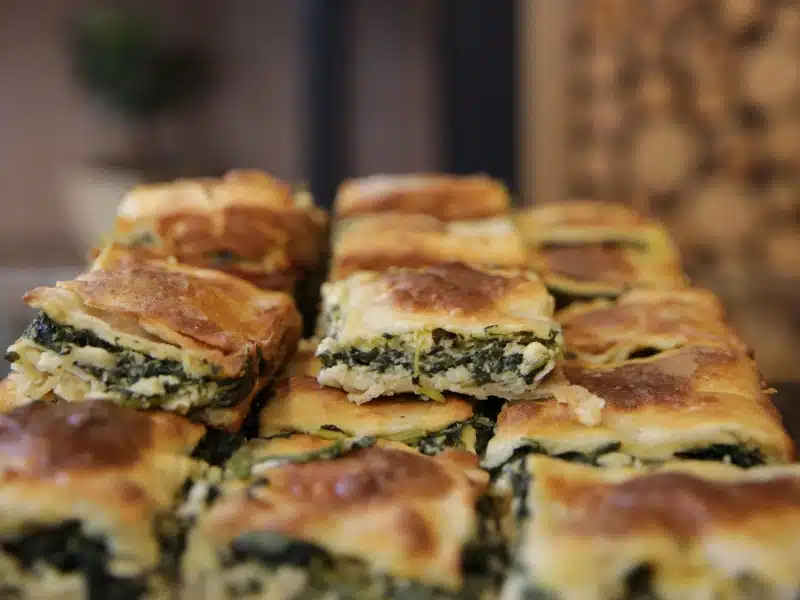 Pastry filled with cheese and spinace cut into squares and stacked