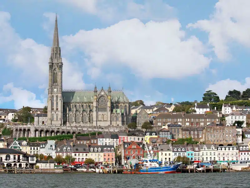 Cobh church with a row of colorful houses in the foreground