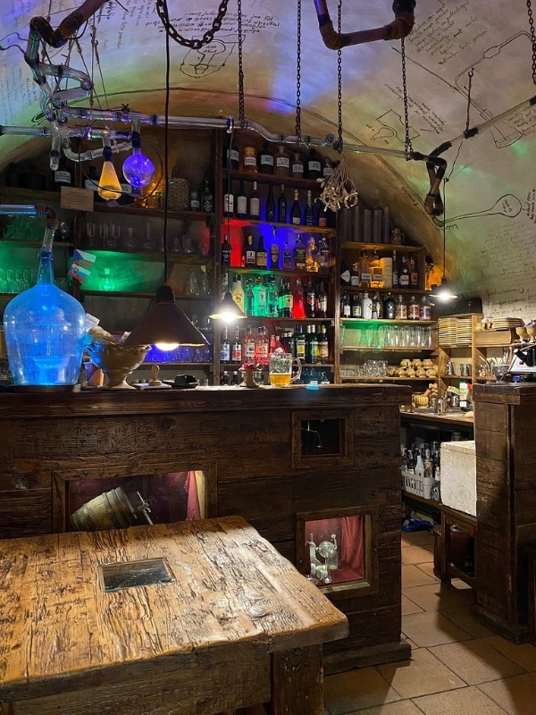 colorful glass bottles behind an old-fashioned bar