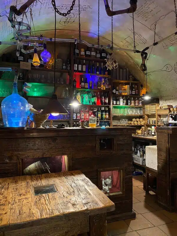 colorful glass bottles behind an old-fashioned bar