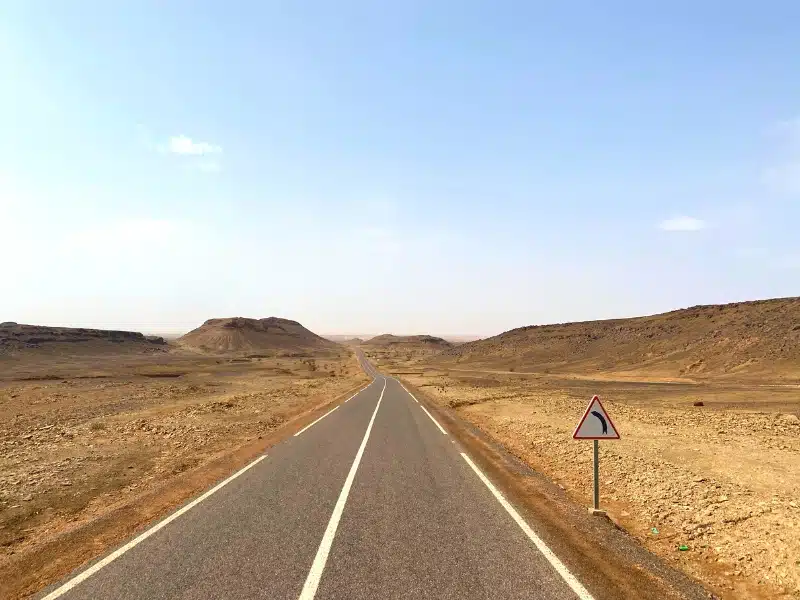 ashphalt road through a desert landscape